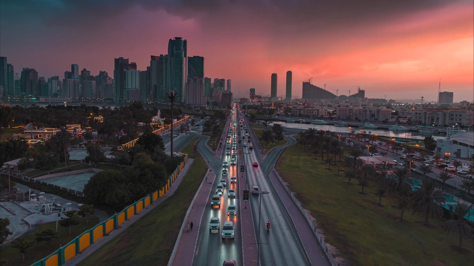 Aerial view of Sharjah cityscape and urban highways at sunset