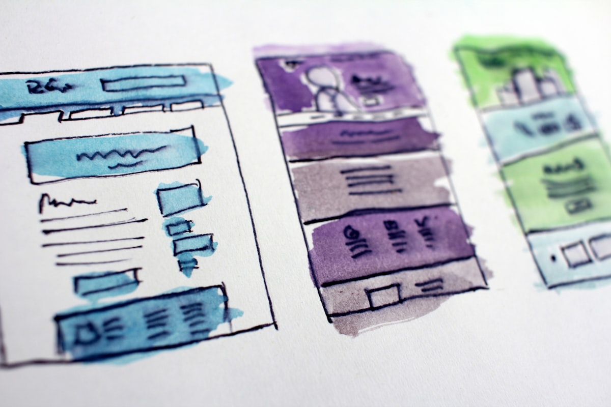 Web designer planning a website layout with sketches and wireframes