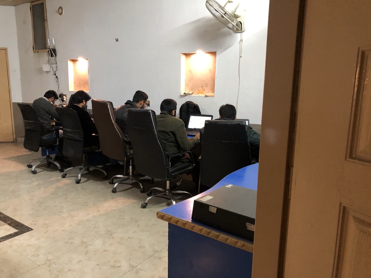 Early days of my web development office — the team working at a shared desk